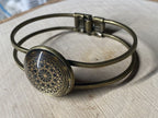 Armband - Dodecagram der heiligen Geometrie als nachtschwarzer ca. 25 mm großer Coin (ginter Glas) mit Goldlegierung in ein bronzefarbendes Schapparmband eingearbeitet, Kupfer unterlegt