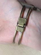 Armband - Dodecagram der heiligen Geometrie als nachtschwarzer ca. 25 mm großer Coin (ginter Glas) mit Goldlegierung in ein bronzefarbendes Schapparmband eingearbeitet, Kupfer unterlegt