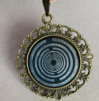 Amulett – bronzefarben, Lakhovsky MWOn Symbol, Disc in schwarz 25 mm, zinnlegiert, kupferunterlegt – Produktansicht 1