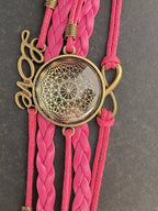 Armband - Dodecagram als nachtschwarzer ca. 25 mm großer Coin (hinter Glas) mit Goldlegierung in pinkes mehrsträngiges Band eingearbeitet