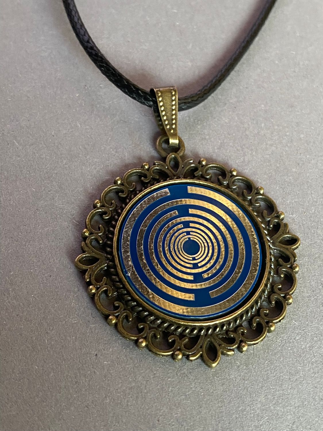 Amulett – bronzefarben, Lakhovsky MWOn Symbol, Disc in blau 25 mm, zinnlegiert, kupferunterlegt – Produktansicht 1